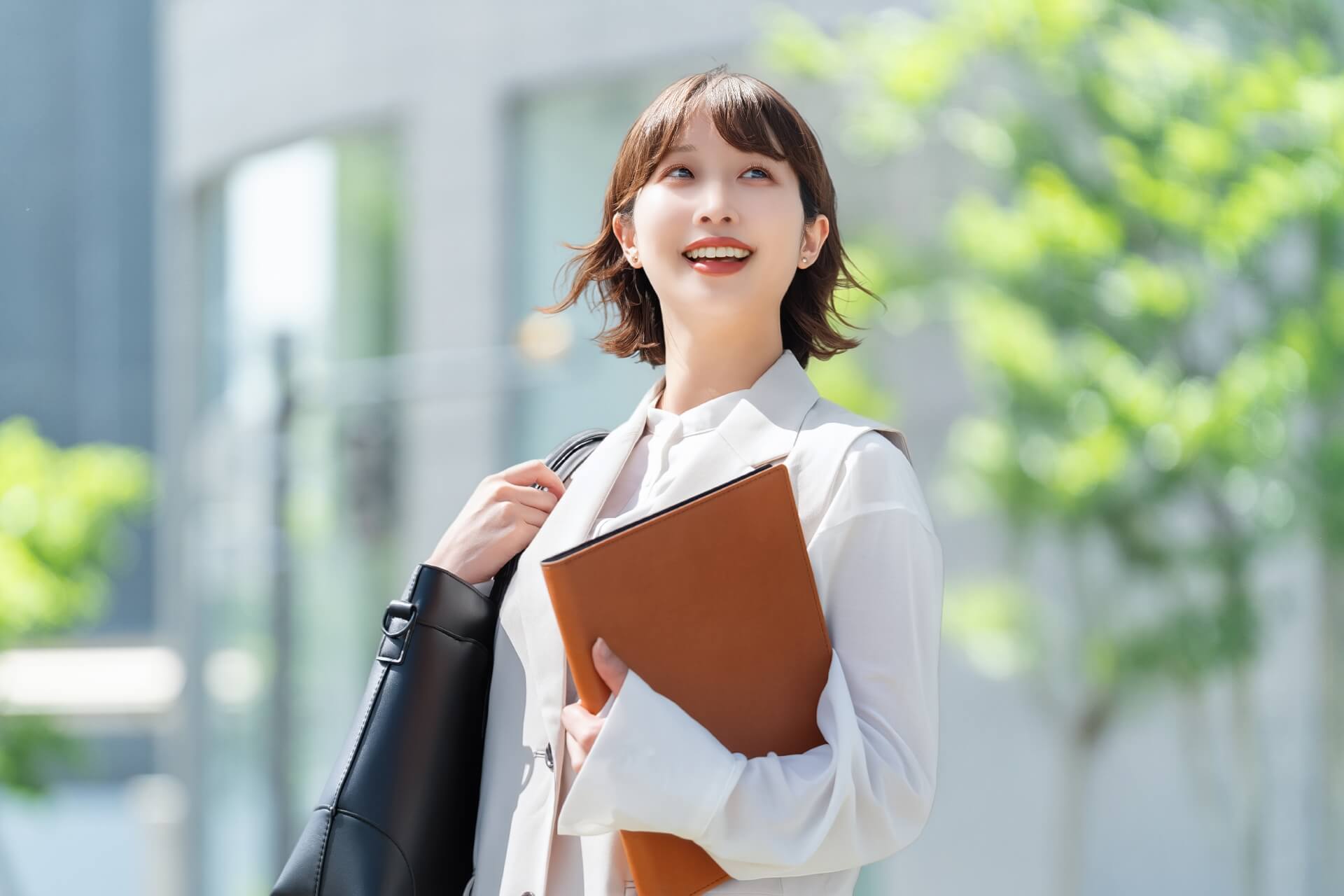 書類を抱えた職場の女性の笑顔